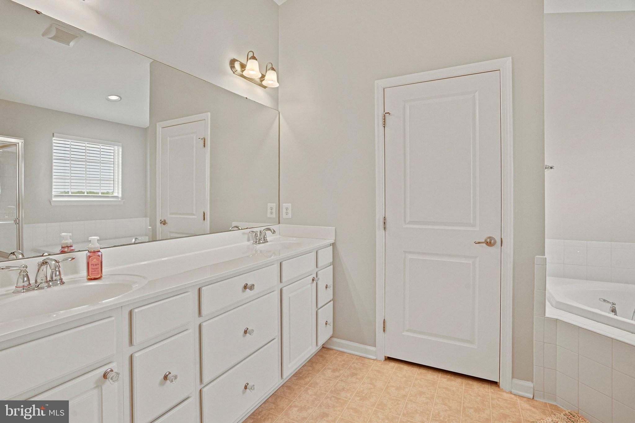 9309 Mount Vernon Way Fort Washington, MD 20744 - Photo 12 of 24 a bathroom with a double vanity sink and a mirror