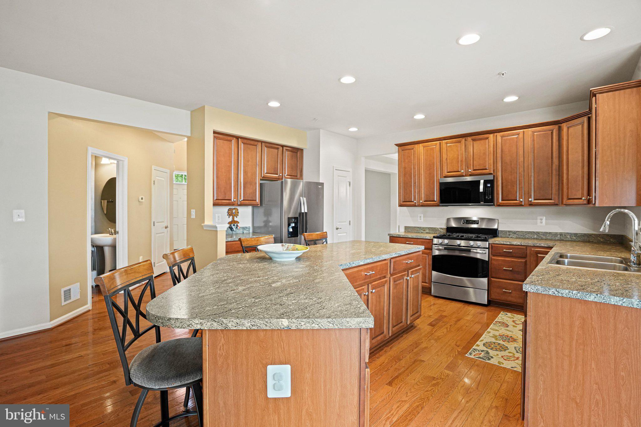 9309 Mount Vernon Way Fort Washington, MD 20744 - Photo 3 of 24 a kitchen with stainless steel appliances granite countertop sink stove top oven and microwave