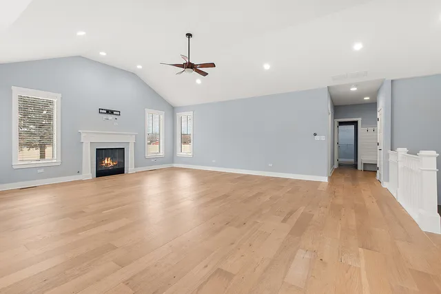 wooden floor in an empty room with a fireplace