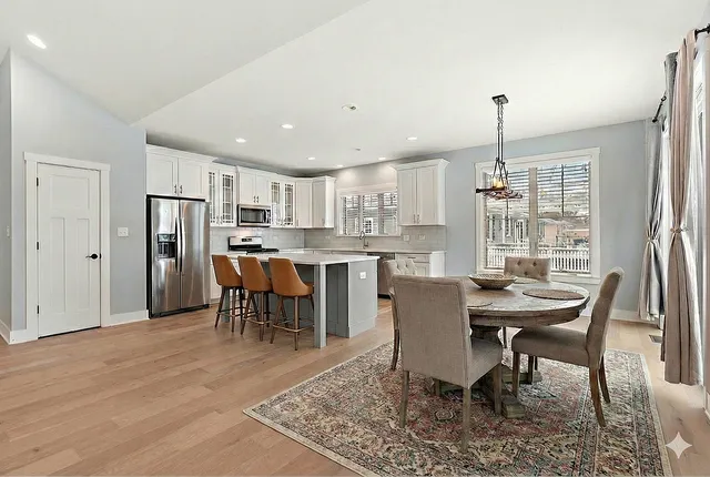 a view of a dining room with furniture and a chandelier