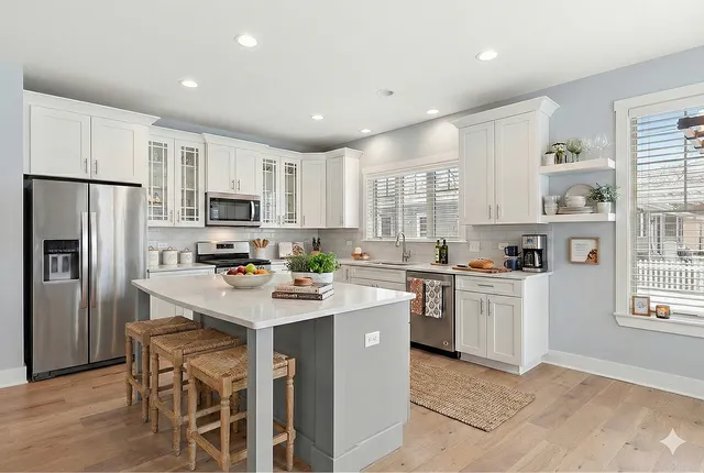 a kitchen with white cabinets and stainless steel appliances
