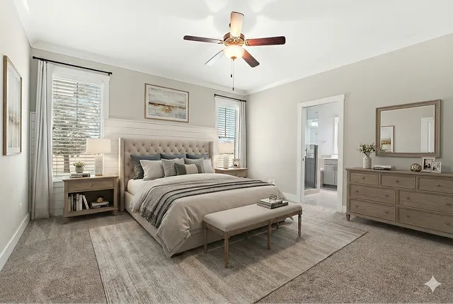 a spacious bedroom with a large bed and a chandelier