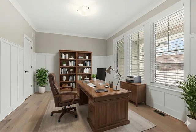 a view of a workspace with furniture and a window