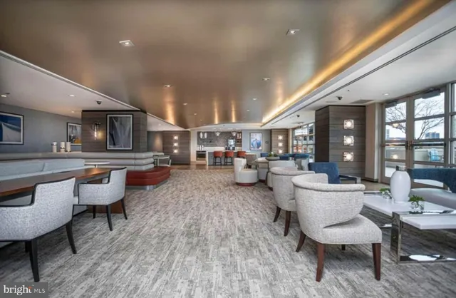 a living room with furniture and kitchen view