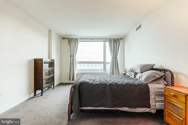 a bedroom with a bed and a window