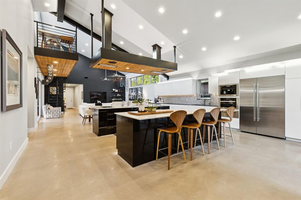 a large kitchen with a large counter top appliances and a refrigerator