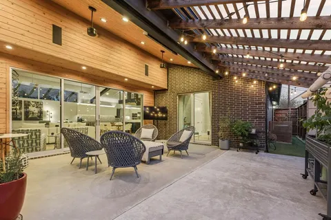 a view of a patio with table and chairs and potted plants