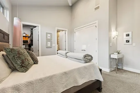 a bedroom with a bed and dresser