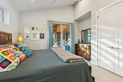 a bedroom with a bed and a dresser in it