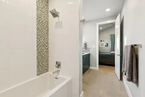 a bathroom with a bathtub and a shower