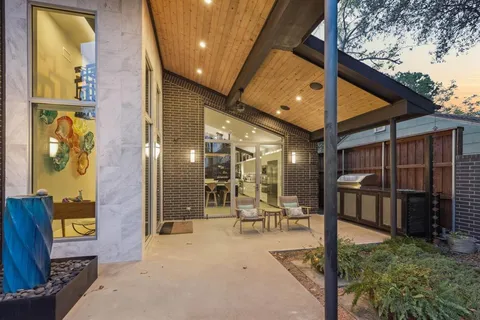 a view of a porch with a table and chairs