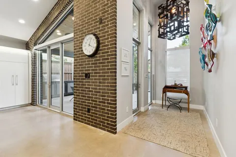 a view of a hallway to rooms