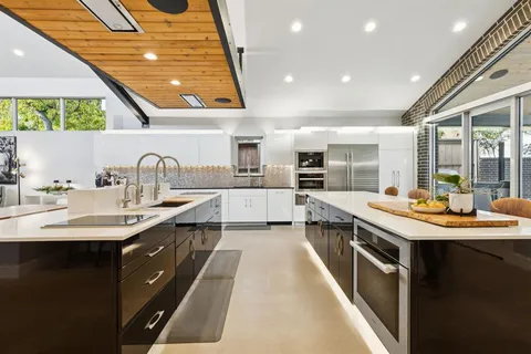 a kitchen with kitchen island a sink and stove