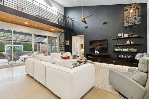 a living room with furniture and chandelier