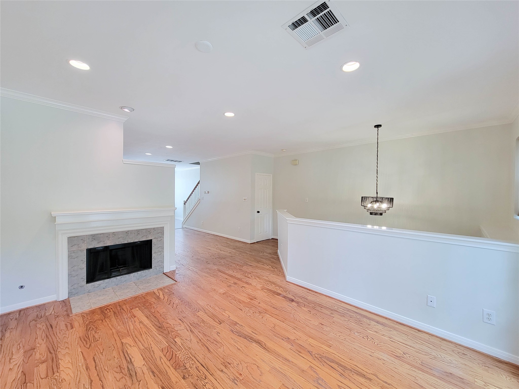3010 La Branch Street Houston, TX 77004 - Photo 11 of 43 a view of an empty room with wooden floor and a fireplace