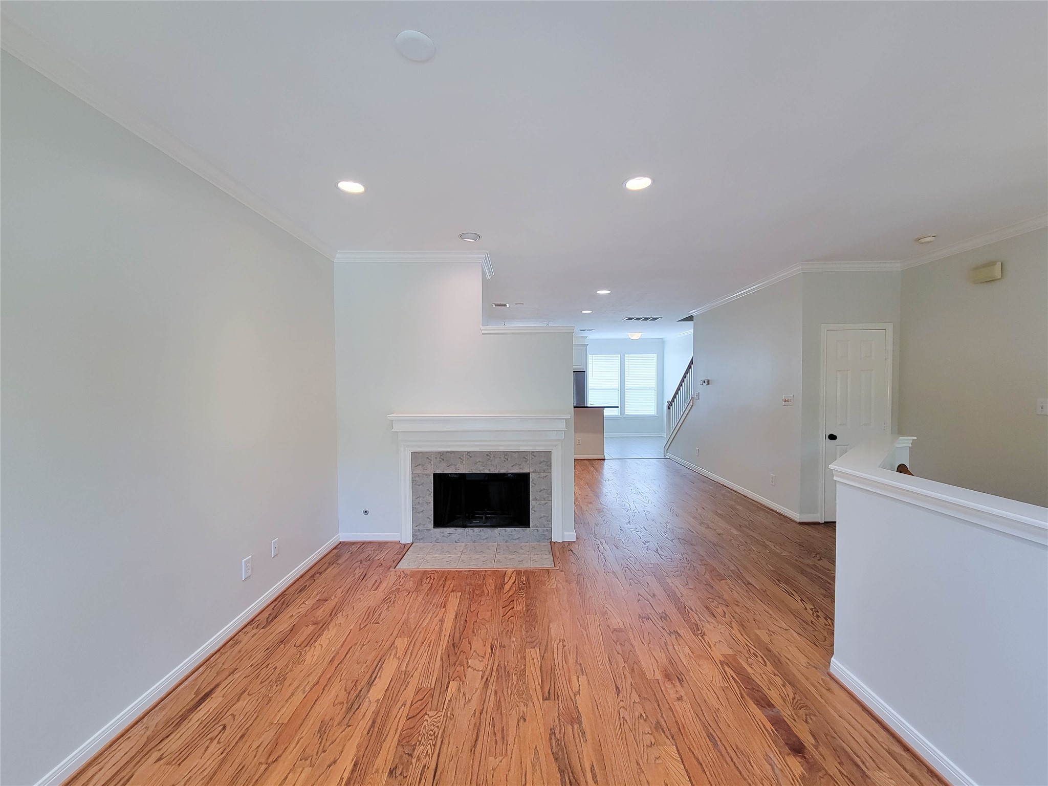 3010 La Branch Street Houston, TX 77004 - Photo 12 of 43 a view of empty room with wooden floor and fireplace