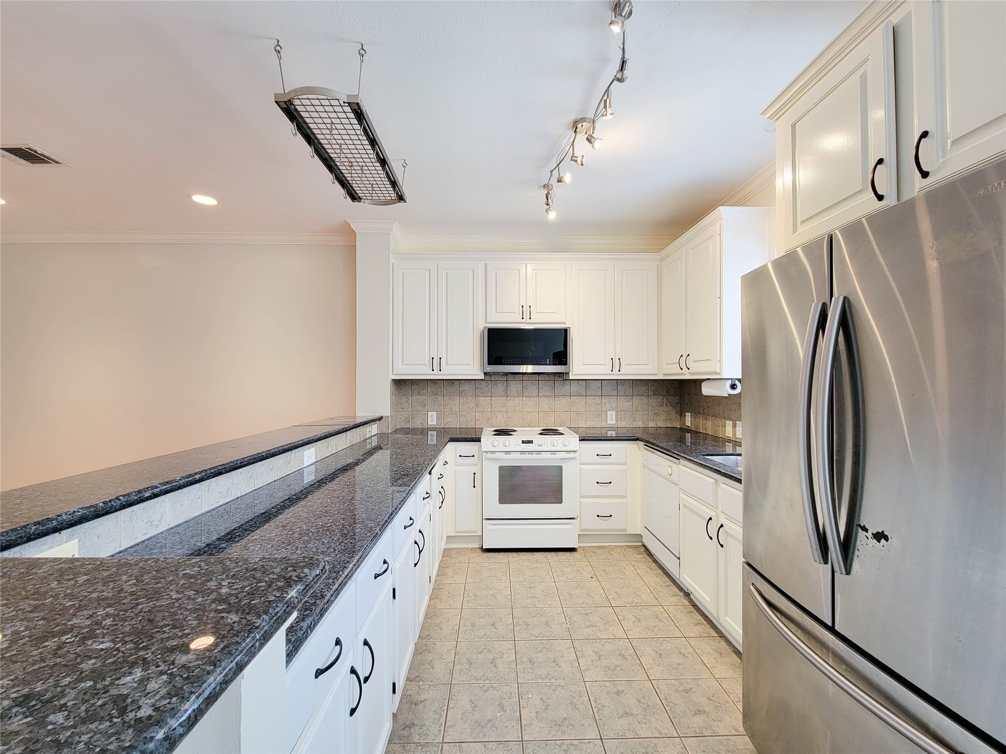 3010 La Branch Street Houston, TX 77004 - Photo 19 of 43 a large kitchen with stainless steel appliances granite countertop a stove a sink and a refrigerator