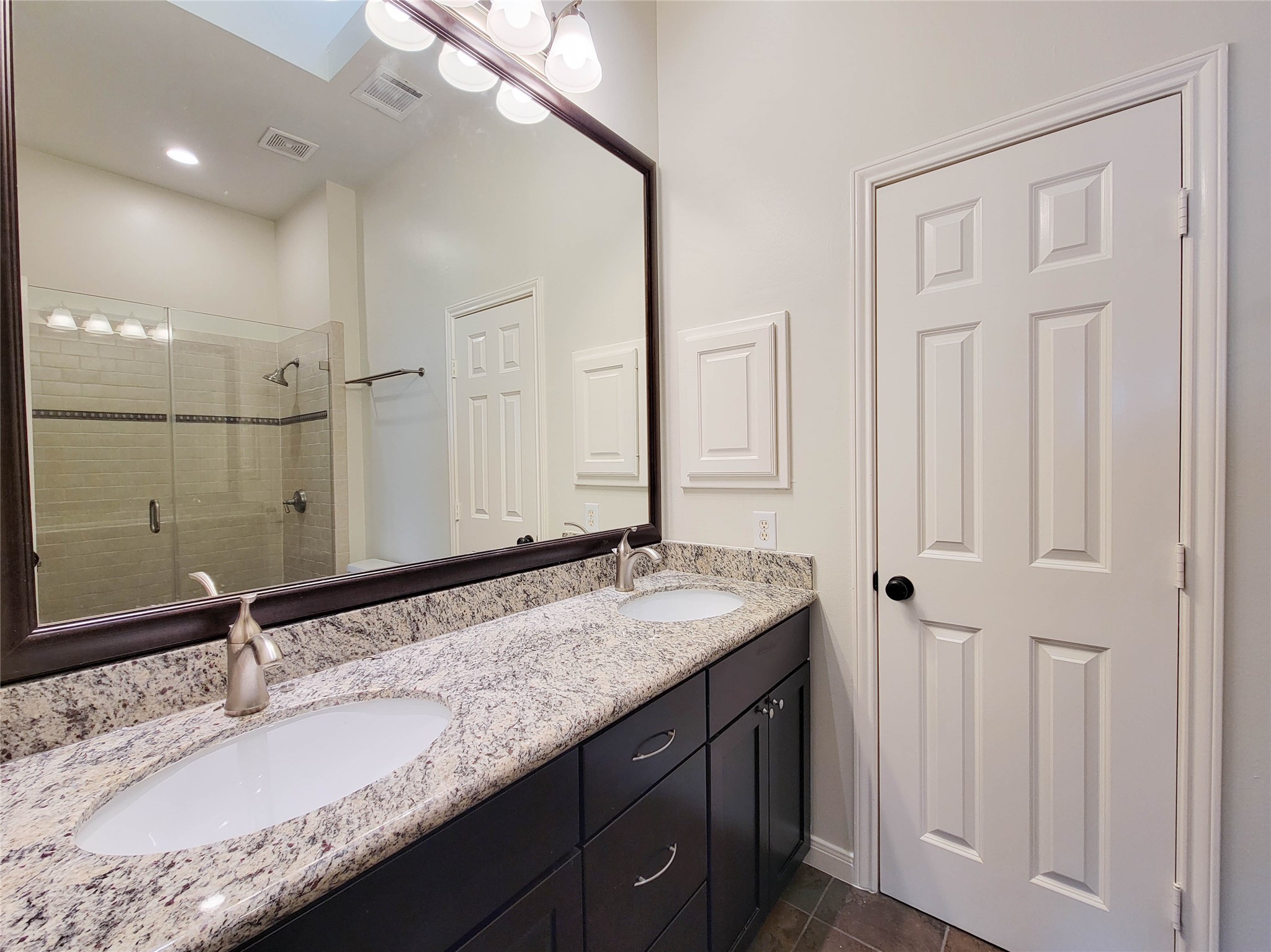 3010 La Branch Street Houston, TX 77004 - Photo 26 of 43 a bathroom with a granite countertop sink and a mirror