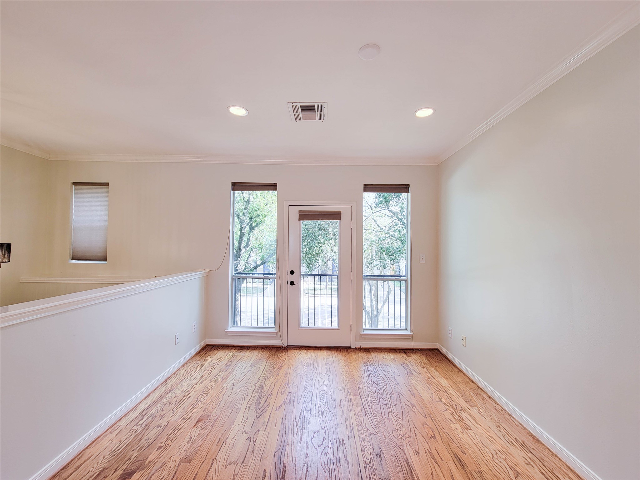 3010 La Branch Street Houston, TX 77004 - Photo 9 of 43 wooden floor in an empty room with a window