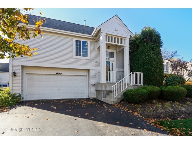 600 South Rosehall Lane Round Lake, IL 60073 - Photo 1 of 16 a front view of a house with a yard and garage