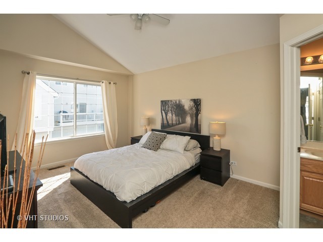 600 South Rosehall Lane Round Lake, IL 60073 - Photo 11 of 16 a bedroom with a bed window and a night stand