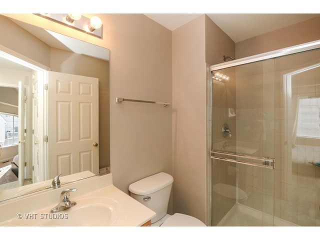 600 South Rosehall Lane Round Lake, IL 60073 - Photo 12 of 16 a bathroom with a toilet and a shower
