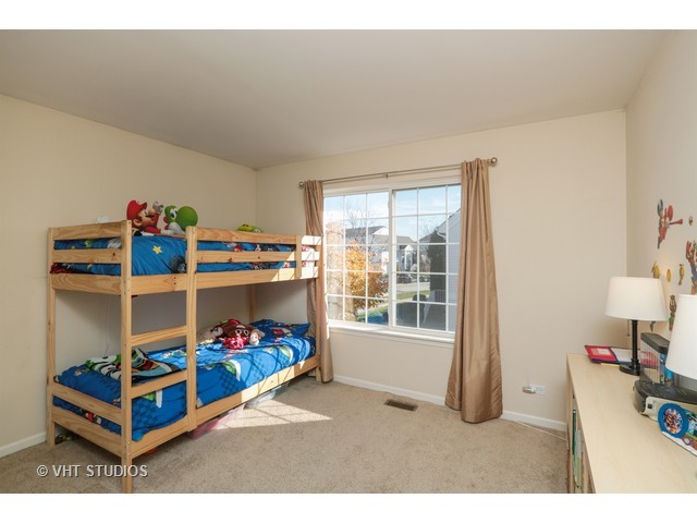 600 South Rosehall Lane Round Lake, IL 60073 - Photo 13 of 16 a bedroom with a bed and a window