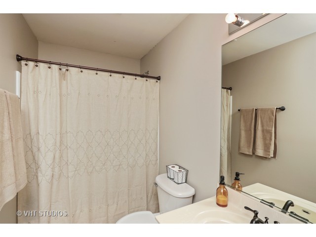 600 South Rosehall Lane Round Lake, IL 60073 - Photo 14 of 16 a bathroom with a toilet and a sink