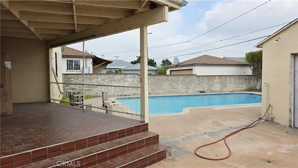 a view of a backyard with furniture and tub