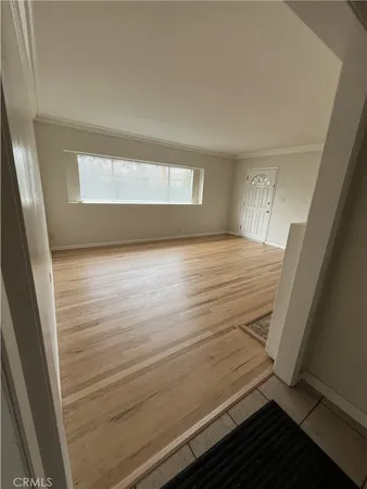 a view of an empty room and wooden floor