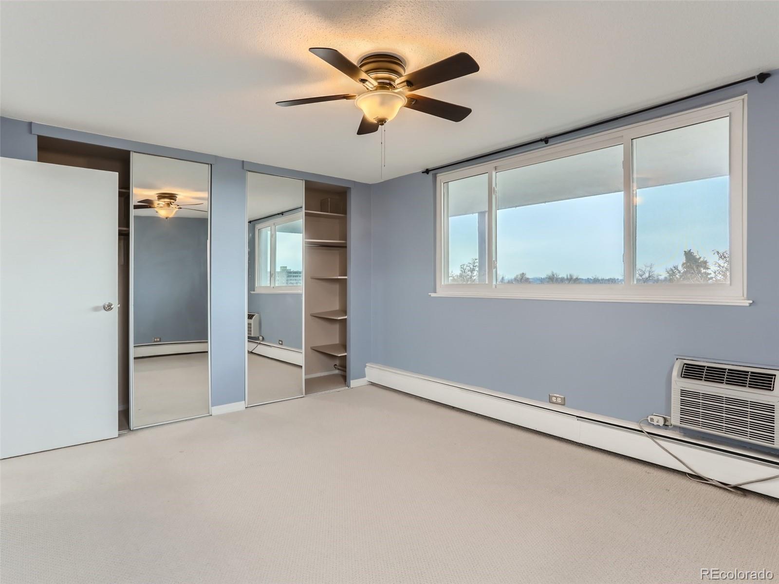 1029 East 8th Avenue, Unit 502 Denver, CO 80218 - Photo 12 of 26 an empty room with closet and windows