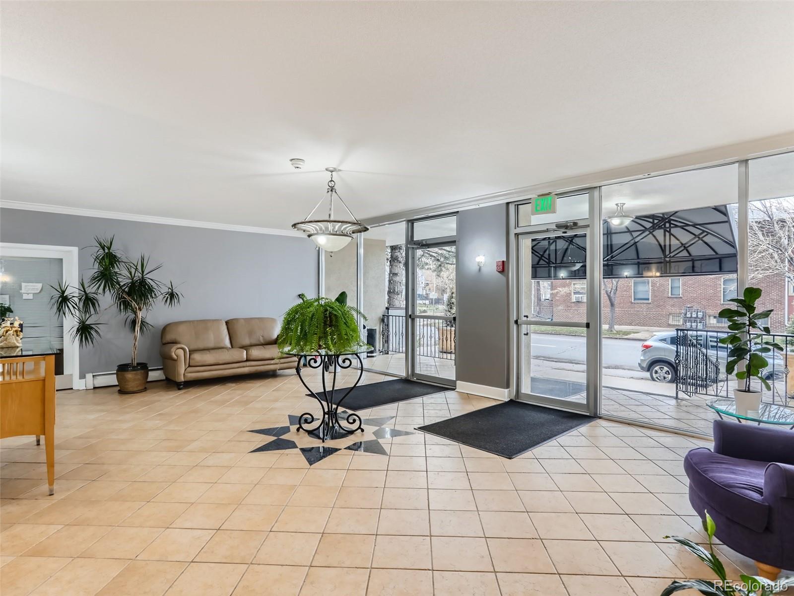 1029 East 8th Avenue, Unit 502 Denver, CO 80218 - Photo 20 of 26 a living room with furniture a potted plant and a table