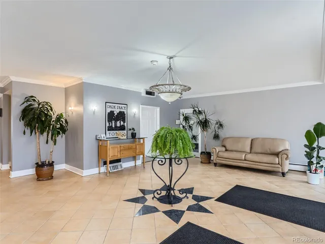 a living room with furniture and a potted plant