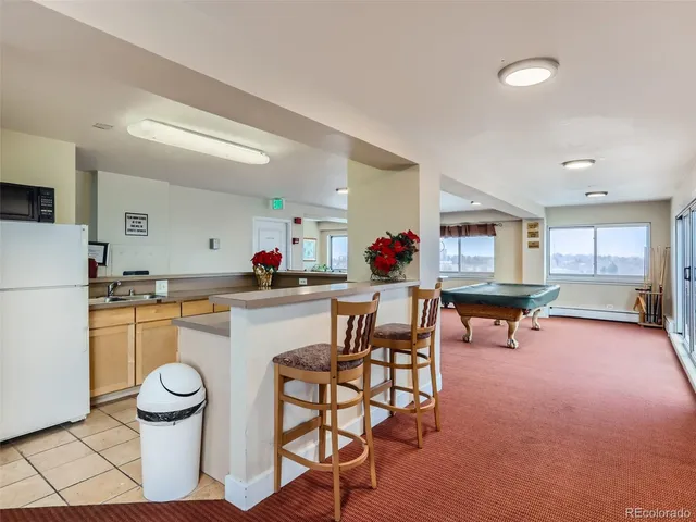 a kitchen with a dining table and chairs