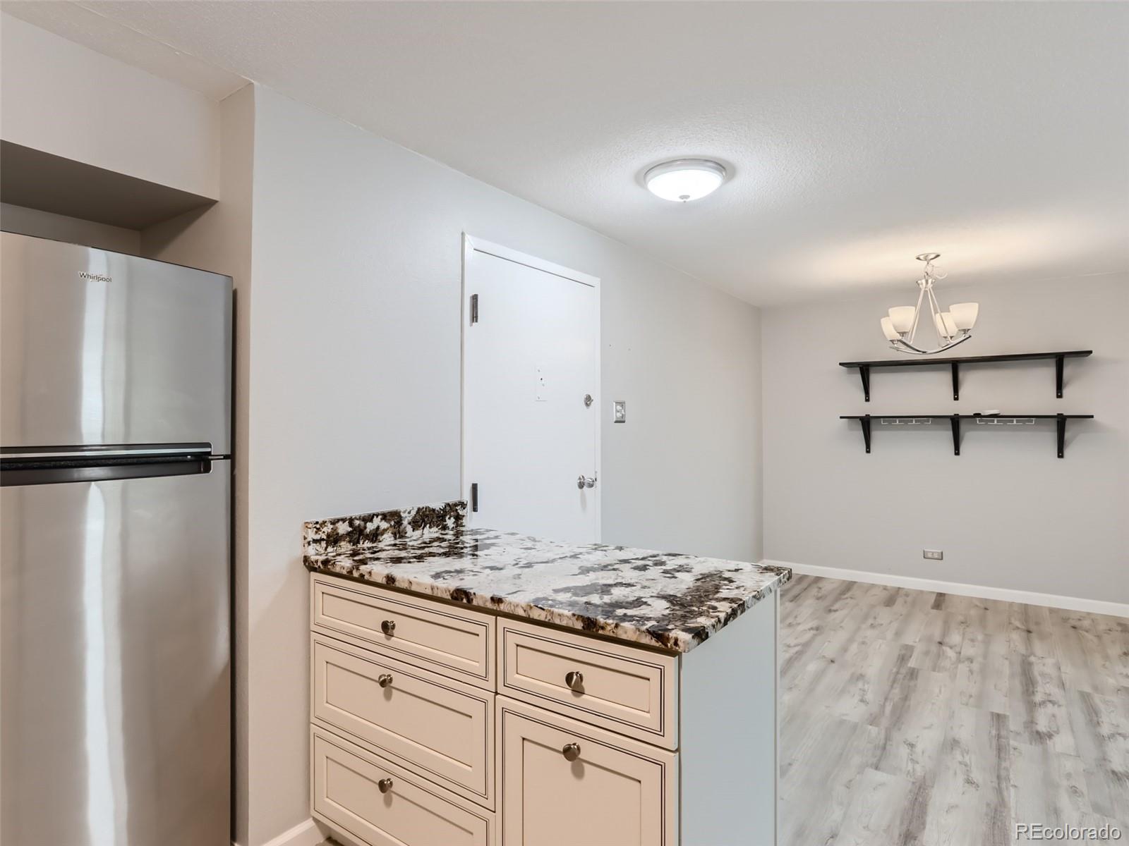 1029 East 8th Avenue, Unit 502 Denver, CO 80218 - Photo 6 of 26 a kitchen with a stove and a refrigerator