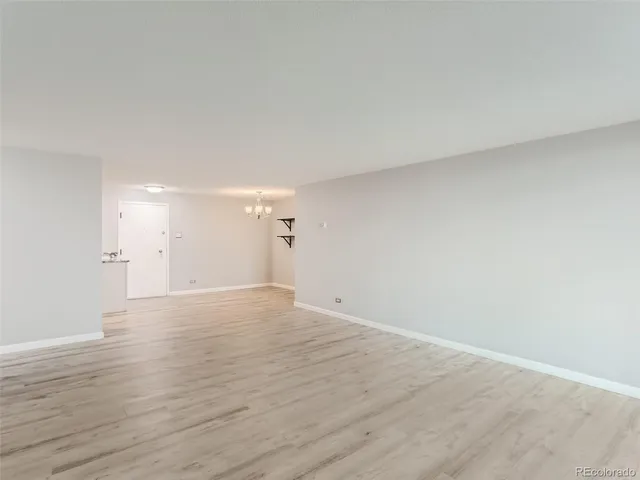 a view of an empty room and wooden floor