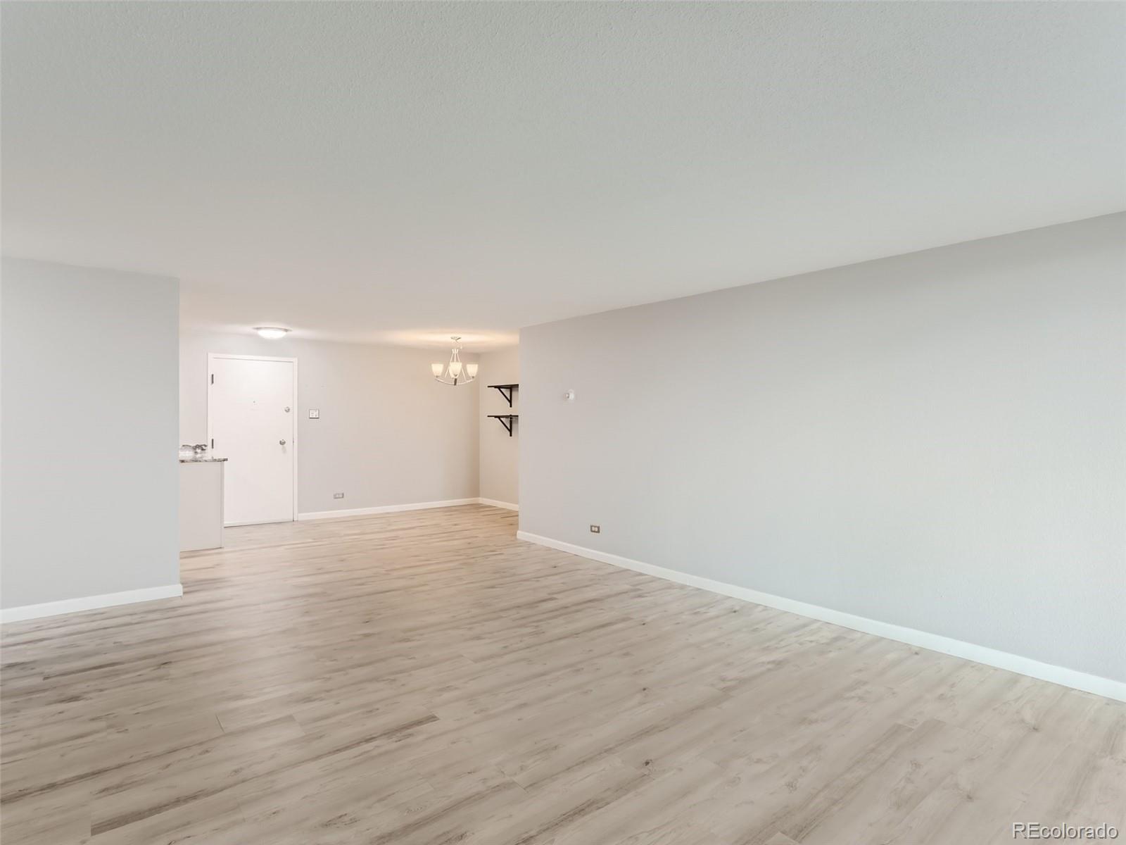 1029 East 8th Avenue, Unit 502 Denver, CO 80218 - Photo 10 of 26 a view of an empty room and wooden floor