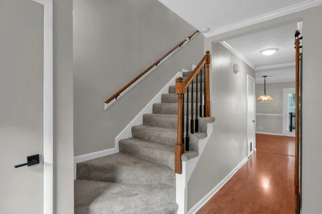 a view of entryway and hall with wooden floor