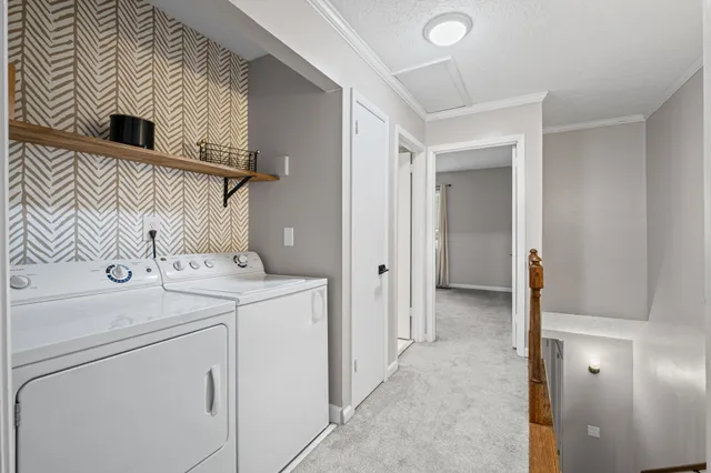a view of storage and utility room with washer and dryer