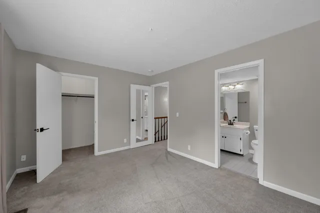 a bathroom with a granite countertop sink a toilet and a bathtub