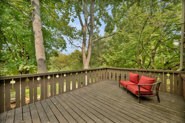 a balcony with wooden floor and furniture