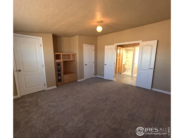 a view of an empty room with a fireplace
