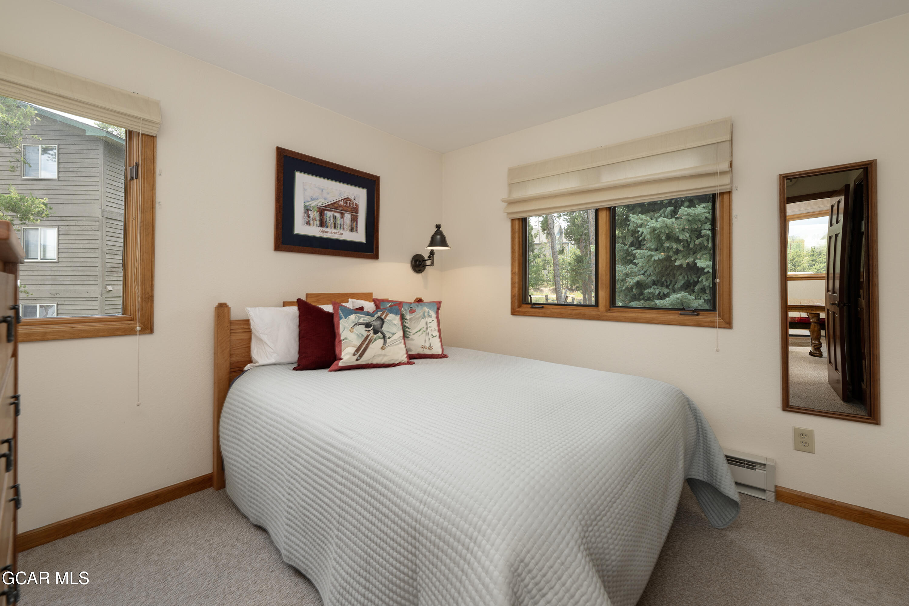 820 Wolverine Lane, Unit 3 Fraser, CO 80442 - Photo 14 of 43 a bedroom with a large bed and a window