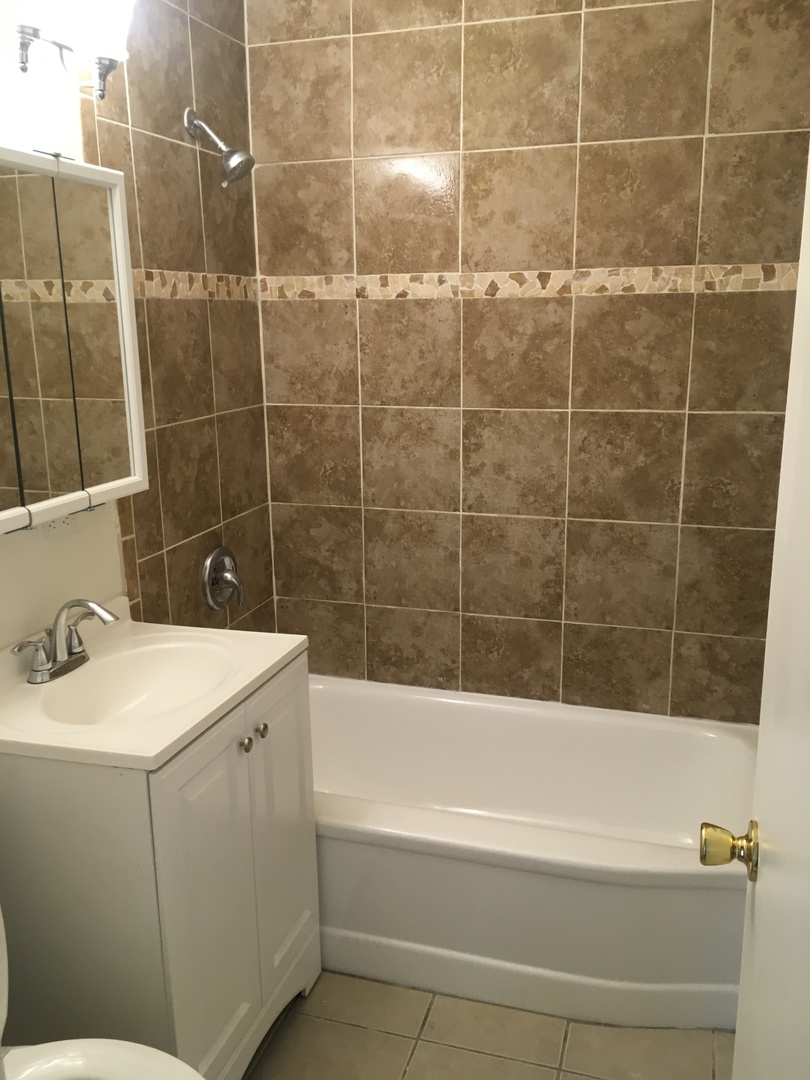 2144 Spruce Road Homewood, IL 60430 - Photo 2 of 13 a bathroom with a sink a toilet and shower