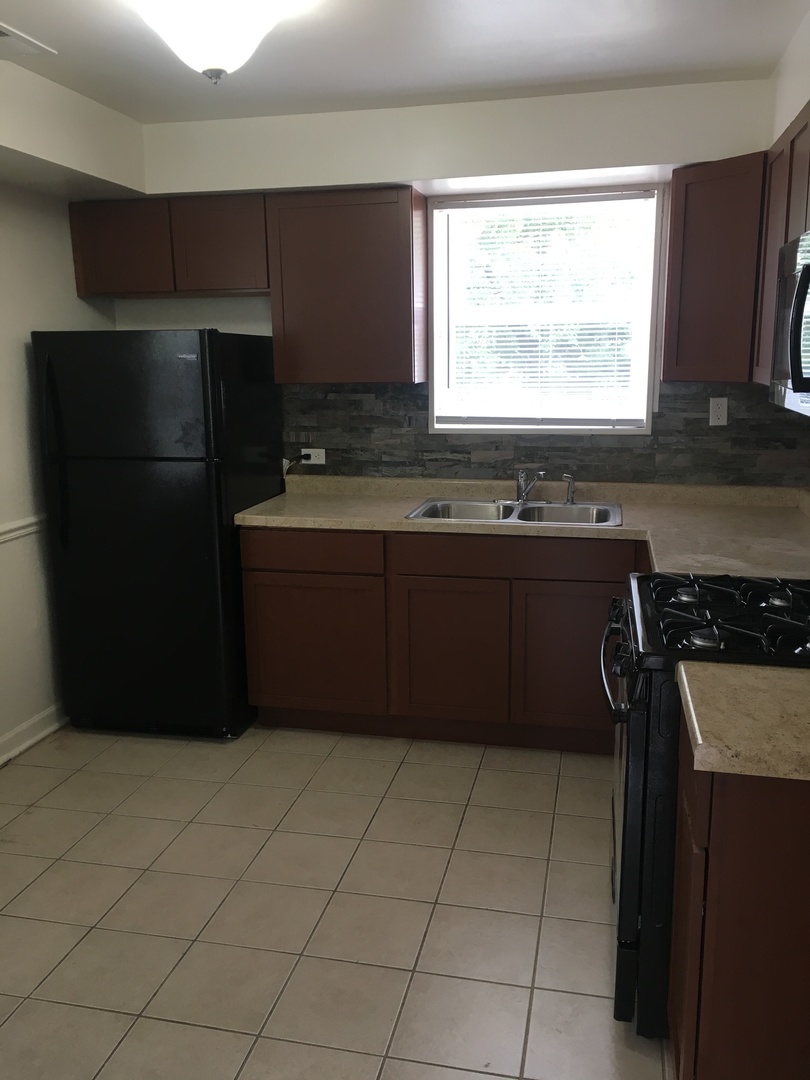 2144 Spruce Road Homewood, IL 60430 - Photo 3 of 13 a kitchen with a refrigerator and a stove