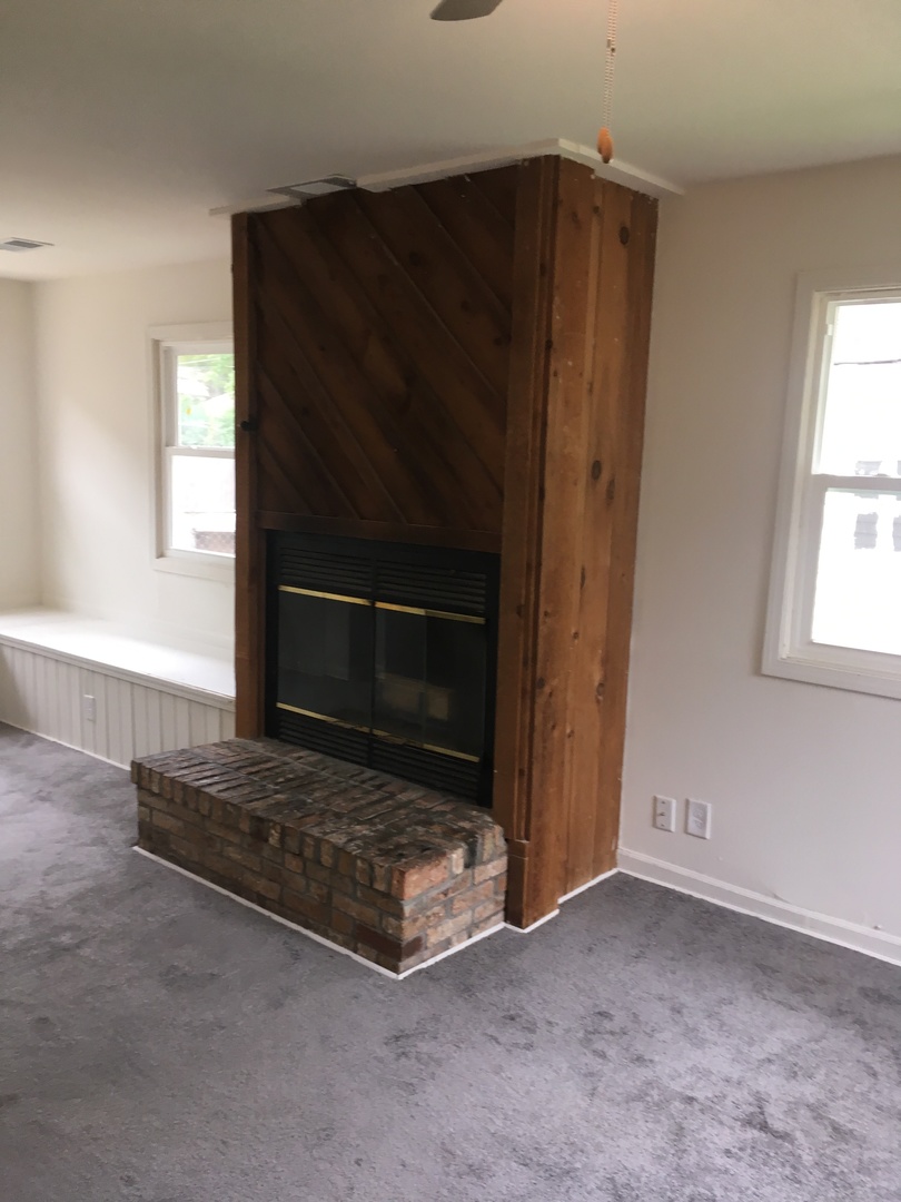 2144 Spruce Road Homewood, IL 60430 - Photo 6 of 13 a living room with a fireplace and a window