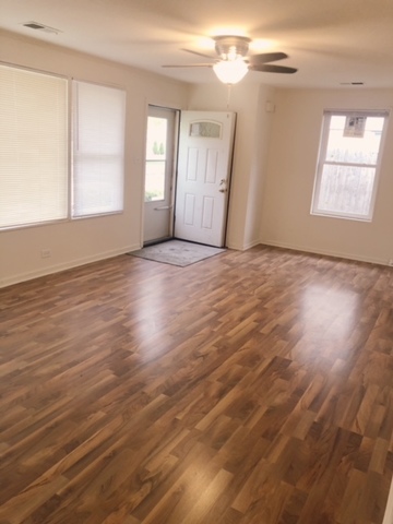 2144 Spruce Road Homewood, IL 60430 - Photo 9 of 13 an empty room with wooden floor and windows