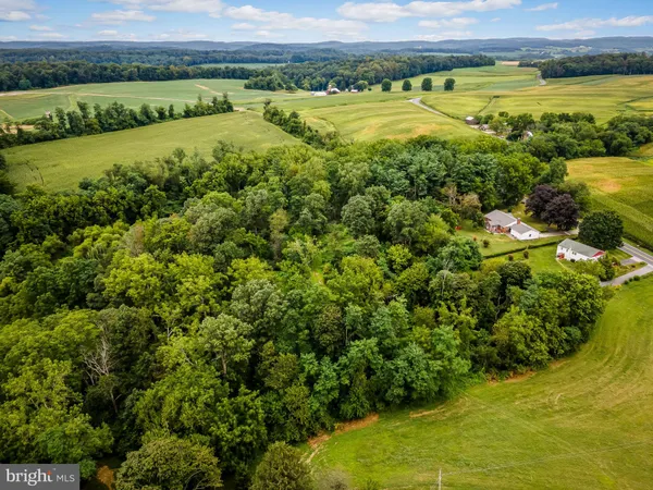 a view of a field with an ocean view