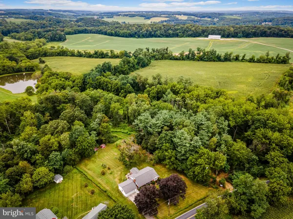 an aerial view of a houses with a lake view
