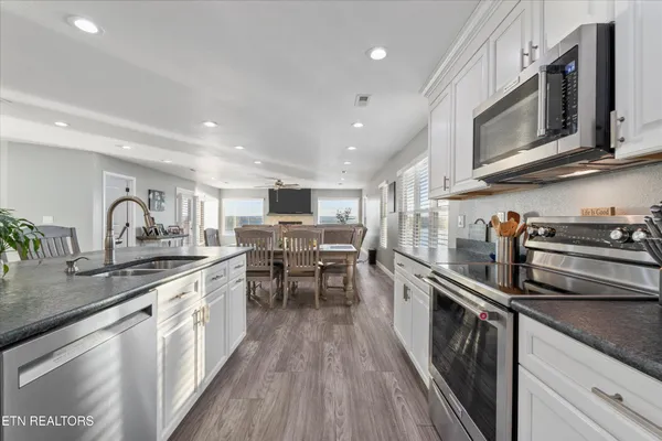 a kitchen with stainless steel appliances granite countertop lots of counter top space a sink and cabinets
